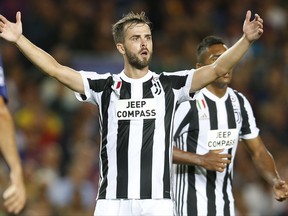 Juventus' Miralem Pjanic reacts to a referee decision during a Champions League group D soccer match between FC Barcelona and Juventus at the Camp Nou stadium in Barcelona, Spain, Tuesday, Sept. 12, 2017. (AP Photo/Francisco Seco)