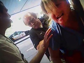 FILE - In this July 26, 2017, file frame grab from video taken from a police body camera and provided by attorney Karra Porter, nurse Alex Wubbels is arrested by a Salt Lake City police officer at University Hospital in Salt Lake City. The case of the police officer caught on video dragging Wubbels from the hospital in handcuffs is now before a Utah police chief to decide possible punishment after a law enforcement oversight board found the detective lost control and got aggressive while his supervisor failed to seek legal advice that could have calmed the situation. (Salt Lake City Police Department/Courtesy of Karra Porter via AP, File)
