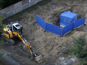 A blue tent covers an unexploded 1.8 tons WW II bomb in Frankfurt, Germany, Friday, Sept. 1, 2017. The bomb is supposed to be defused on Sunday. 70 000 people have to be evacuated. (AP Photo/Michael Probst)