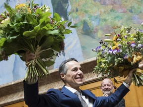 The newly elected Federal Councilor Ignazio Cassis is celebrated after his election by the Swiss parliament, Wednesday, Sept. 20, 2017 in the National Council in Bern, Switzerland. Cassis of the free-market Radical Liberal party outpaced two rivals from French-speaking regions to win the Federal Council seat. (Peter Klaunzer/Keystone via AP)