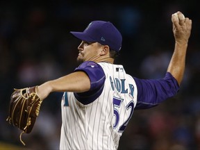 Arizona Diamondbacks' Zack Godley throws a pitch against the Colorado Rockies during the first inning of a baseball game Thursday, Sept. 14, 2017, in Phoenix. (AP Photo/Ross D. Franklin)