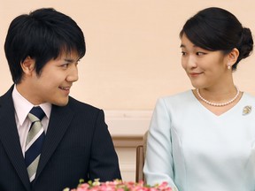 Princess Mako, the eldest daughter of Prince Akishino and Princess Kiko, and her fiancee Kei Komuro, smile during a press conference to announce their engagement at the Akasaka East Residence in Tokyo on Sept. 3, 2017.