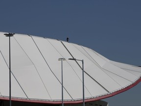 In this photo taken on Thursday, Sept. 14, 2017, a worker walks on the roof of the new Wanda Metropolitano Stadium in Madrid, Spain. Atletico Madrid will get closer to the past when it moves into its new stadium. The state-of-the-art venue inaugurated on Saturday, Sept. 16, 2017  will thrust the traditional Spanish club into modernity while not letting go of its rich history. (AP Photo/Paul White)