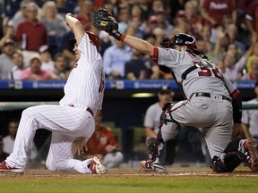 Philadelphia Phillies' Tommy Joseph, left, scores past the tag from Washington Nationals catcher Matt Wieters on a two-run double by Cameron Rupp during the third inning of a baseball game, Tuesday, Sept. 26, 2017, in Philadelphia. (AP Photo/Matt Slocum)