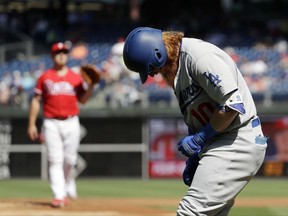 Los Angeles Dodgers' Justin Turner, right, reacts after getting hit by a pitch from Philadelphia Phillies starting pitcher Mark Leiter Jr. during the first inning of a baseball game, Thursday, Sept. 21, 2017, in Philadelphia. (AP Photo/Matt Slocum)