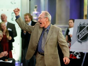 In this Oct. 2, 2014 file photo, longtime Chicago Blackhawks captain Pierre Pilote raises his fist at an unveiling ceremony for a new Original Six stamp at the Hockey Hall of Fame in Toronto.