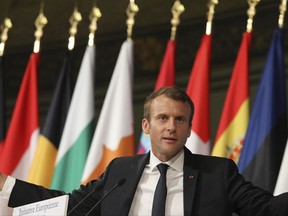 French President Emmanuel Macron gestures after delivering a speech on the European Union at the amphitheater of the Sorbonne university in Paris, France, Tuesday, Sept. 26, 2017. Macron is laying out his vision Tuesday for a more unified Europe, with a joint budget for countries sharing the euro currency and a stronger global voice despite Brexit looming. (Ludovic Marin/Pool Photo via AP)