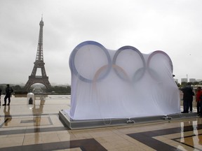 Paris officials set up a display of the Olympic rings on Trocadero plaza that overlooks the Eiffel Tower, ahead of the vote in Lima, Peru, awarding the 2024 Games to the French capital, France, Wednesday, Sept. 13, 2017. Paris is certain of getting the 2024 Olympics so it has been able to plan its celebrations in advance. The International Olympic Committee is expected to confirm the award later Wednesday. (AP Photo/Francois Mori)