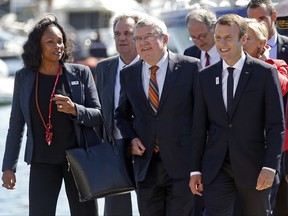 French President Emmanuel Macron, right, International Olympic Committee (IOC) President Thomas Bach, center, and French Minister for Sports Laura Flessel arrive for a meeting at the city hall as part of a visit to the site of the future Olympic Sailing venue (Voile Olympique) at the "Marina Olympique" nautical base in Marseille, southern France, after the decision for Paris to host of the 2024 Summer Olympics Games, Thursday, Sept. 21, 2017. (Jean-Paul Pelissier/Pool Photo via AP)