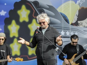 Leader of the Five Stars Moviment, Beppe Grillo performs on the stage during a meeting in Rimini, Italy, Saturday, Sept. 23, 2017 (Filippo Pruccoli/ANSA via AP)