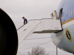 In this Monday, Sept. 18, 2017 photo a visitor to the "Air Force One Experience," a full-sized 747 replica of Air Force One which is now open to the public walks down the steps after exiting the front hath in North Kingstown, R.I. (AP Photo/Stephan Savoia)