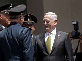 Accompanied by Mexico's Defense Secretary Gen. Salvador Cienfuegos Zepeda, far left, U.S. Defense Secretary Jim Mattis takes part in a reception ceremony in Mexico City, Friday, Sept. 15, 2017. Mattis was meeting with senior Mexican government officials in the capital on the eve of Mexico's national Independence Day. (AP Photo/Rebecca Blackwell)