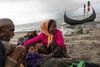 Rohingya refugees comfort an elderly woman, after the wooden boat they were travelling on from Myanmar crashed into the shore and tipped everyone out on Sept. 12, 2017 in Dakhinpara, Bangladesh.