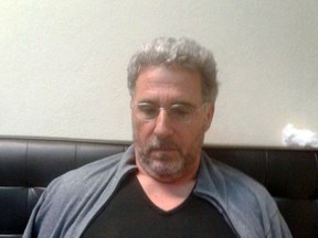 In this photo taken on Sunday, Sept. 3, 2017, a man identified by Italian Police as longtime fugitive Rocco Morabito looks down after being arrested in a Montevideo hotel, Uruguay. Italian authorities say a top 'ndrangheta crime syndicate boss, on the run since 1994, has been arrested in Uruguay where he had been living under a false name and with a forged Brazilian passport. Reggio Calabria Chief Prosecutor Federico Cafiero de Raho said Monday longtime fugitive Rocco Morabito played a big role in cocaine trafficking between South America and Milan, a distribution point for the drug to be sold elsewhere. The Calabria-based 'ndrangheta is one of the world's biggest cocaine traffickers. (Italian Police via AP)