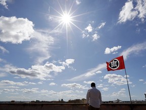 In this photo taken on Wednesday, Sept. 20, 2017, CasaPound militant Davide Di Stefano looks at the skyline from the rooftop of the CasaPound headquarters in Rome. Created as a social movement to help under-privileged Italians, a small neo-fascist group has been grabbing headlines and gaining notoriety with its sometimes violent opposition to migrants arriving in Italy. But CasaPound, which combines progressive policies such as gay rights and abortion with die-hard nationalism, is also attracting supporters across Italy. (AP Photo/Andrew Medichini)