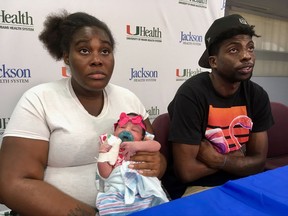 Tatyanna Watkins and her boyfriend, David Knight, hold a news conference Wednesday, Sept. 13, 2017, at Miami's Jackson Memorial Hospital to discuss the birth of their daughter, Destiny Knight, who was born Sunday as Hurricane Irma was approaching South Florida. With emergency responders unable to make it to the scene, Watkins gave birth while she and Knight listened to instructions from a doctor over the phone. (AP Photo/Adriana Gomez Licon)