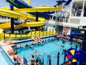In this Thursday, Sept. 7, 2017 photo, passengers aboard the Norwegian Escape cruise ship relax in a pool just hours before the huge vessel returned to Miami, two days earlier than scheduled due to powerful Hurricane Irma. Some passengers disembarked Thursday, while others chose to remain on board the ship, which was scheduled to leave later that evening for safe waters. (AP Photo/Brian Witte)