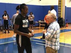 New York Liberty WNBA basketball player Tina Charles talks with Dan Carlson after practice at the team training center in Greenburgh, N.Y., Friday, Sept. 1, 2017. One of the hundreds of defibrillators that Charles has donated over the past four years wound up saving Carlson's life when he had a heart attack in July. (AP Photo/Doug Feinberg)
