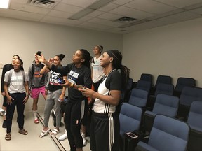 Sugar Rodgers, far right, holds the controller alongside Shavonte Zellous, center, while they play NBA Live while Tina Charles and other New York Liberty teammates look on Saturday, Sept. 9, 2017 at the team's practice facility in Tarrytown, N.Y. (AP Photo/Doug Feinberg)