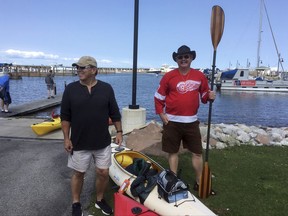 In an Aug. 25, 2017 photo, Jim Schuster, left, and Kevin Hull return to a Lake Huron marina in Port Austin, Mich., after finding waves too rough for their kayaks. They paddled safely to shore.  US kayak sales are up 55 percent since 2009 as more people chose a relatively inexpensive way to get on water. But some law enforcement officials say they're concerned about novices who underestimate the risks of paddling in big open water like the Great Lakes. AP Photo/Ed White)