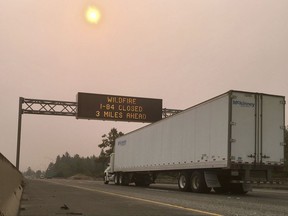 A sign warns of a highway closure on Interstate 84 in Troutdale, Ore., Tuesday, Sept. 5, 2017. A lengthy stretch of the highway east of Portland, Ore., remains closed Tuesday morning as crews battle a growing wildfire that has also caused evacuations and sparked blazes across the Columbia River in Washington state. (AP Photo/Gillian Flaccus)