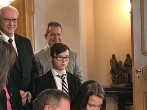 Madison Malinowski, 10, helps Ohio Gov. John Kasich sign "Judy's Law," named for her mother, at the Ohio Statehouse in Columbus, Ohio, Thursday, Sept. 7, 2017. Before her death, 33-year-old Judy Malinowski was hospitalized for nearly two years after her ex-boyfriend doused her with gasoline and set her on fire in August 2015. The law adds six years to prison terms for crimes that maim or disfigure victims. (AP Photo/Julie Carr Smyth)