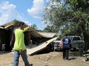 Rafael and Silvia Casas tour the wreckage of their family home near the San Jacinto River in Crosby, Texas, Friday, Sept. 1, 2017. The working class neighborhood was completely destroyed Harvey's flood waters, which had receded enough Friday for residents to return and view the wreckage. (AP Photo/Jason Dearen)