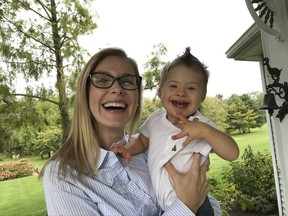 In this undated photo, Kelly Kuhns holds her son, Oliver, in Plain City, Ohio. Kuhns is advocating for an Ohio bill that would ban abortions based on the type of pre-natal Down syndrome diagnosis she received for her son, Oliver. (AP Photo/Julie Carr Smyth)
