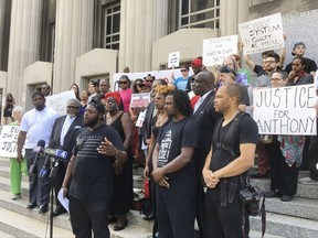 In this Aug. 28, 2017, photo, activists gather outside the St. Louis courthouse where former police officer Jason Stockley's murder trial was heard. They are threatening significant protest if a judge fails to convict Stockley, including possible shutdown of highways, Lambert Airport and downtown businesses. Stockley is charged with fatally shooting Anthony Lamar Smith in 2011 after a chase. (AP Photo/Jim Salter)