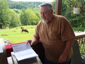 Ken Morcom refers to a letter from the Pennsylvania Department of Environmental Protection as he speaks about the contamination of his water well on Aug. 24, 2017, at his home in Dimock, Pa. The federal government is back for the first time in more than five years to investigate ongoing claims of contamination in Dimock, which became a battleground in the debate over gas drilling and fracking. (AP Photo/Michael Rubinkam)