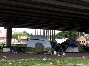 In this Wednesday, Aug. 30, 2017, photo, dozens of homeless people live beneath an overpass for Interstate 59 in Houston. Many of the inhabitants of the tent camp braved Hurricane Harvey there and shrug off the severity of the storm, even as advocates for the homeless fear the aftermath could hit them hardest. (AP Photo/Matt Sedensky)