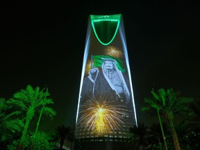 In this Sunday, Sept. 24, 2017 photo released by the Saudi Culture and Information Ministry, the image of King Salman and Crown Prince Mohammed bin Salman are projected on the Kingdom Tower during National Day ceremonies in Riyadh, Saudi Arabia. A new 62-page report by Human Rights Watch finds that despite Saudi Arabia's recent efforts toward reform, some state-backed clerics continue to "incite hatred and discrimination against religious minorities" while text books stigmatize minorities, particularly Muslim Shiites. (Saudi Culture and Information Ministry via AP)