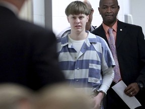 FILE - In this Monday, April 10, 2017, file photo, Dylann Roof enters the court room at the Charleston County Judicial Center to enter his guilty plea on murder charges in Charleston, S.C. Roof, a white supremacist who was sentenced to death in the 2015 massacre of nine black worshippers, has told a federal appeals court he wants to fire his appellate attorneys because one of them is Jewish and the other is Indian. In a handwritten request filed Monday, Sept. 18,  with the 4th U.S. Circuit Court of Appeals in Richmond, Va., Roof wrote that his attorneys' backgrounds are "a barrier to effective communication." (Grace Beahm/The Post And Courier via AP, Pool, File)