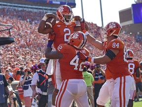 Clemson's Kelly Bryant (2) celebrates a touchdown with Christian Wilkins (42) and Cannon Smith during the first half of an NCAA college football game against Boston College, Saturday, Sept. 23, 2017, in Clemson, S.C. (AP Photo/Richard Shiro)