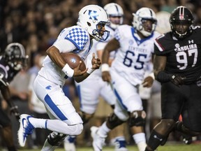 Kentucky quarterback Stephen Johnson carries during the first half as South Carolina's Kobe Smith defends during an NCAA college football game Saturday, Sept. 16, 2017, in Columbia, S.C. (AP Photo/Sean Rayford)