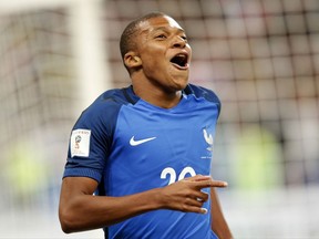 France's Kylian Mbappe reacts after scoring France' s fourth goal during the World Cup Group A qualifying soccer match between France and The Netherlands at the Stade de France stadium in Saint-Denis, outside Paris, Thursday, Aug.31, 2017. (AP Photo/Christophe Ena)