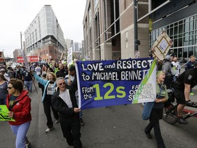 Demonstrators show support for Seattle Seahawks defensive end Michael Bennett as they march outside CenturyLink Field before an NFL football game between the Seahawks and the San Francisco 49ers, Sunday, Sept. 17, 2017, in Seattle. Bennett has been a vocal supporter of Black Lives Matter and other social issues. (AP Photo/John Froschauer)