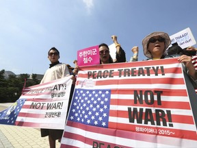 Protesters shout slogans during a rally against the deployment of an advanced U.S. missile defense system called Terminal High-Altitude Area Defense, or THAAD, near the presidential Blue House in Seoul, South Korea, Friday, Sept. 8, 2017. Dozens of people were injured in clashes between South Korean protesters and police Thursday as the U.S. military added more launchers to the high-tech missile-defense system it installed in a southern town to better cope with North Korean threats. (AP Photo/Ahn Young-joon)