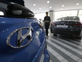 FILE -  In this July 26, 2017, file photo, the logo of Hyundai Motor Co. is seen on a car displayed at its showroom in Seoul, South Korea. Hyundai Motor Co. said its China plant halted operation due to a supply disruption on Tuesday, Sept. 5, 2017 its second shutdown in China in less than a month as diplomatic tensions between China and South Korea over a U.S. missile-defense system took toll on its business. (AP Photo/Ahn Young-joon, File)