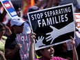 A demonstrator holds a sign while protesting the end of the Deferred Action for Childhood Arrivals (DACA) program in Washington, D.C., U.S., on Tuesday, Sept. 5, 2017.