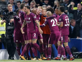 Manchester City's scorer Kevin De Bruyne, center, and his teammates celebrate the opening goal during their English Premier League soccer match between Chelsea and Manchester City at Stamford Bridge stadium in London, Saturday, Sept. 30, 2017. (AP Photo/Frank Augstein)