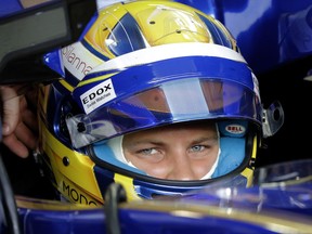 Sauber driver Marcus Ericsson of Sweden waits in his car during the first practice session at the Singapore Formula One Grand Prix on the Marina Bay City Circuit Singapore, Friday, Sept. 15, 2017. (AP Photo/Wong Maye-E)
