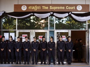 Thai police women stand guard outside the Supreme Court in Bangkok, Thailand, Wednesday, Sept. 27, 2017. The court is expected to deliver verdict on case against former Prime Minister Yingluck Shinawatra. (AP Photo/Sakchai Lalit)