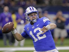 FILE - In this Saturday, Sept. 2, 2017, file photo, BYU quarterback Tanner Mangum (12) passes against LSU in the first half of an NCAA college football game in New Orleans. BYU coach Kalani Sitake didn't hesitate to that say a change is needed on the offensive side of the ball after the Cougars had one of the worst outings in recent history last weekend. (AP Photo/Scott Threlkeld, File)