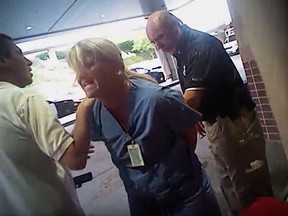 FILE - In this July 26, 2017, frame grab from video taken from a police body camera and provided by attorney Karra Porter, nurse Alex Wubbels is arrested by a Salt Lake City police officer at University Hospital in Salt Lake City. Authorities say a Utah police officer whose rough arrest of a nurse has drawn condemnation put the woman in handcuffs even after investigators told him not to worry about getting a blood sample. (Salt Lake City Police Department/Courtesy of Karra Porter via AP, File)