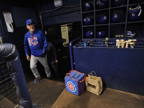 Chicago Cubs manager Joe Maddon walks into the visitor's dugout during warmups before a baseball game against the Tampa Bay Rays Tuesday, Sept. 19, 2017, in St. Petersburg, Fla. (AP Photo/Steve Nesius)