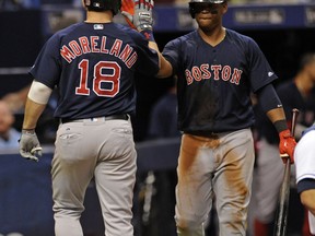 Boston Red Sox's Rafael Devers, right, congratulates Mitch Moreland (18) on his solo home run off Tampa Bay Rays starter Matt Andriese during the fourth inning of a baseball game Friday, Sept. 15, 2017, in St. Petersburg, Fla. (AP Photo/Steve Nesius)