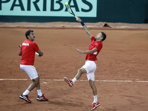 Filip Krajinovic, left, and Nenad Zimonjic of Serbia return the ball to Pierre-Hugues Herbert and Nicolas Mahut of France during their double Davis Cup semi final match at the Pierre Mauroy stadium in Lille, northern France, Saturday, Sept.16, 2017. (AP Photo/Michel Spingler)