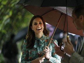 FILE - In this Wednesday, Aug. 30, 2017 file photo Britain's Prince William and his wife Kate, Duchess of Cambridge smile as they walk through the memorial garden in Kensington Palace, London. Kensington Palace says Prince William and his wife, the Duchess of Cambridge, are expecting their third child. The announcement released in a statement Monday Sept. 4, 2017 says the queen is delighted by the news. (AP Photo/Kirsty Wigglesworth, File)
