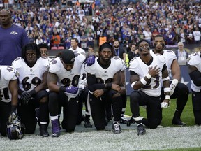 Baltimore Ravens players kneel down during the playing of the U.S. national anthem before an NFL football game against the Jacksonville Jaguars at Wembley Stadium in London, Sunday Sept. 24, 2017. (AP Photo/Matt Dunham)